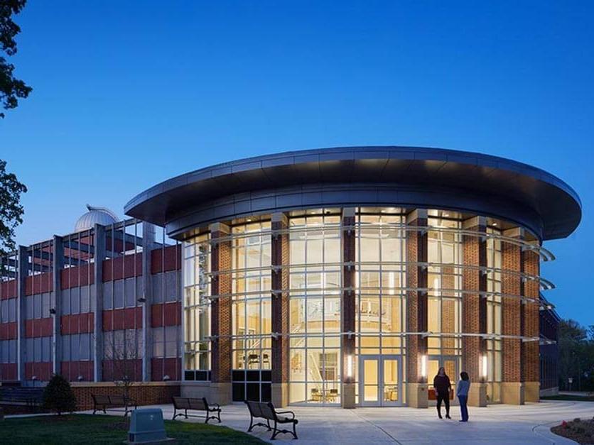 The exterior of George Hall lit up at night